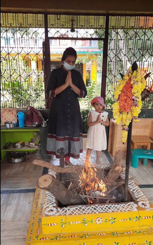 Devotees offering a prayer at the Nitya Agni Homa Kunda
