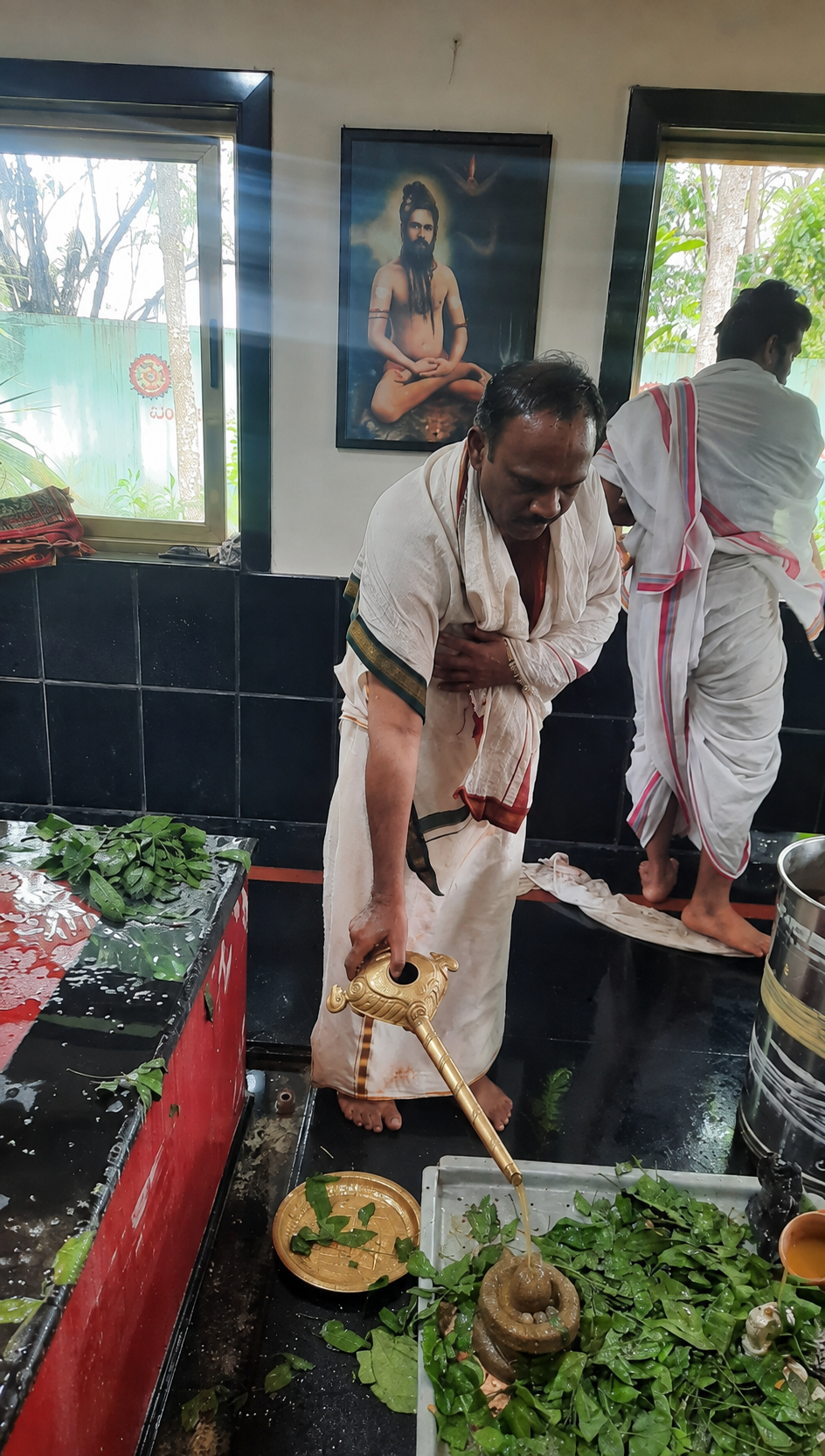 Rudra Abhishekam being performed to the Guru Padukas